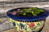 Bangkok Grand Palace, Wat Phra Keow (temple of the Emerald Buddha). Lotus flowers decorate the raised platform. 